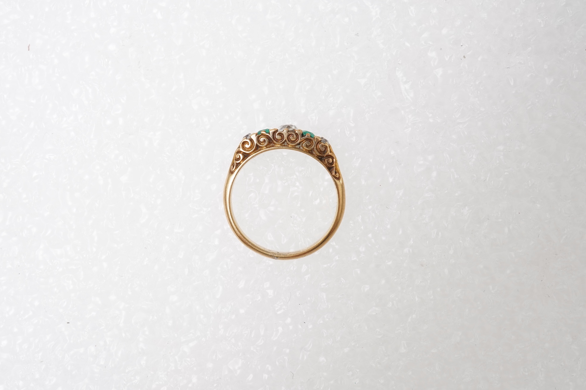 An emerald and diamond five-stone ring, circa 1900